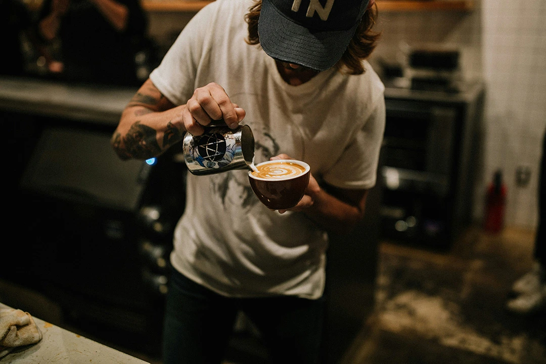barista pouring latte at a doodle cafe in windsor